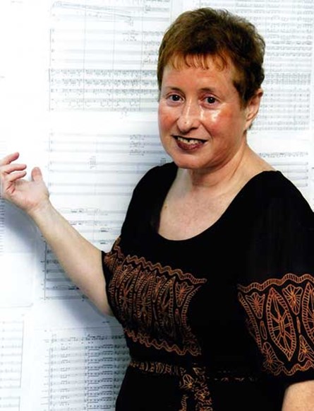 Tsippi Fleischer against the background of the score of Symphony No. 5 (The Tsippi Fleischer Archive, MUS 0121)