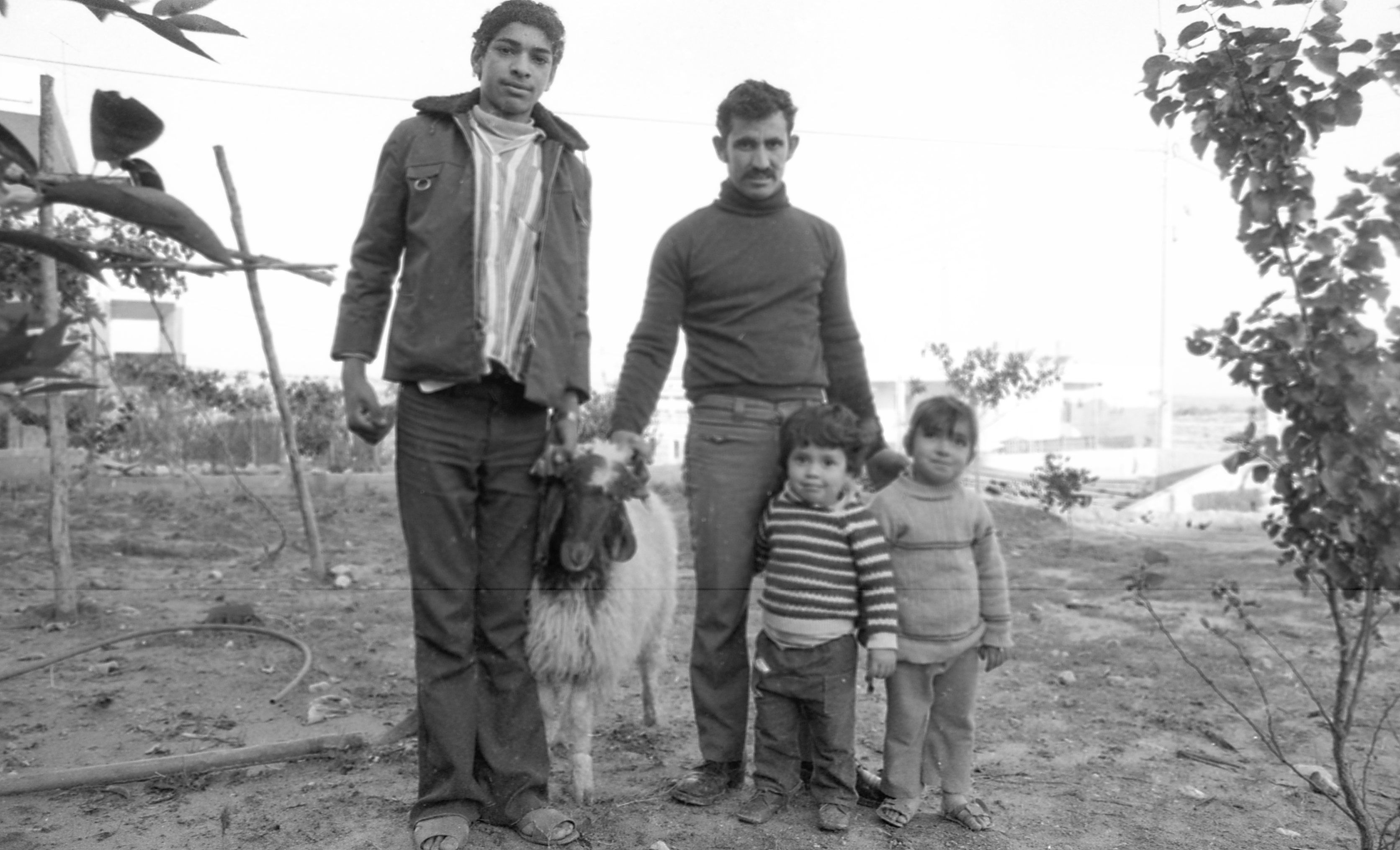 family with kids sucrificing a goat